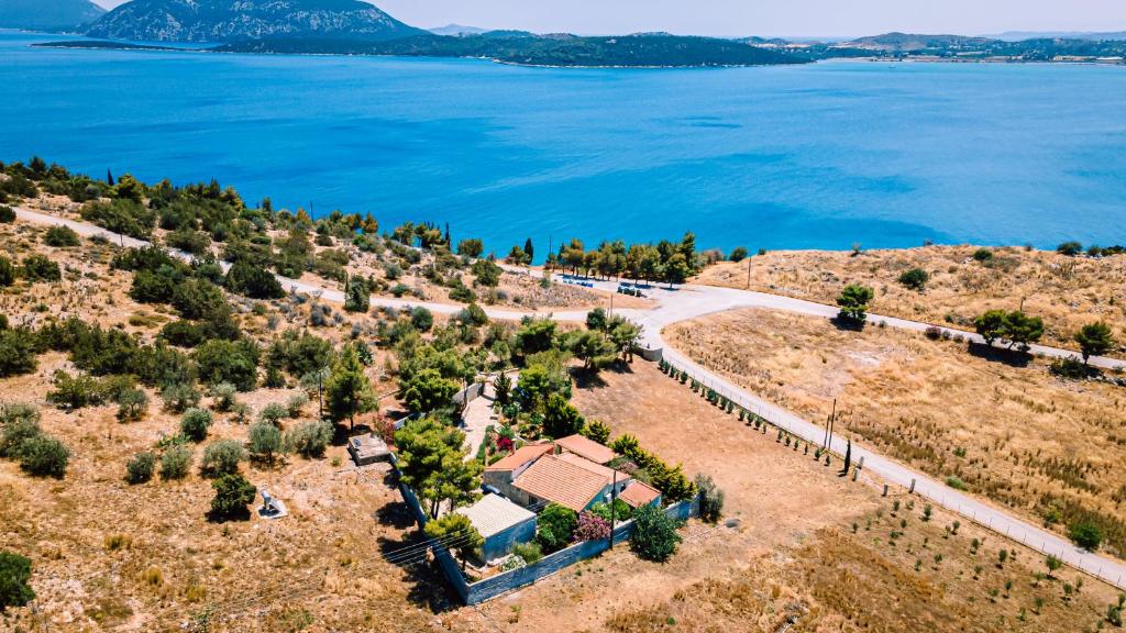 an aerial view of a house next to the water at Villa Angelos in Ermioni