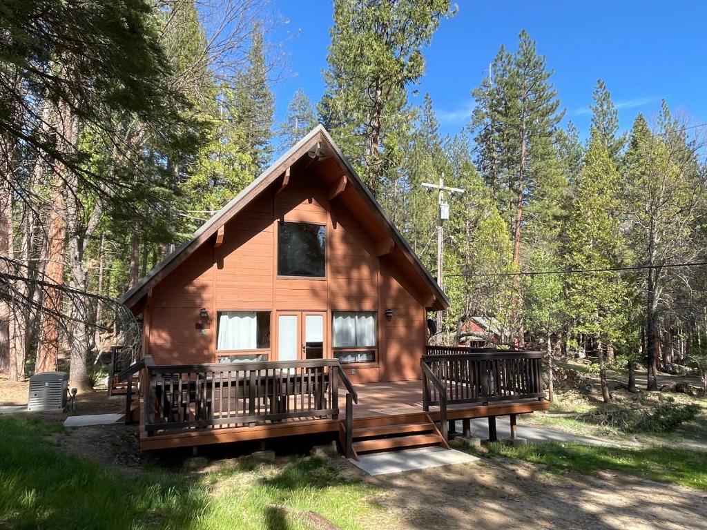 a cabin in the woods with two decks at Avid Hiker Lodge in Wawona