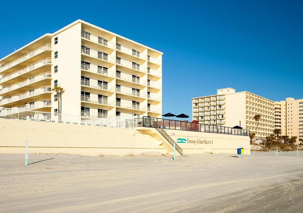 a large apartment building in front of a beach at Fantasy Island II in Daytona Beach Shores
