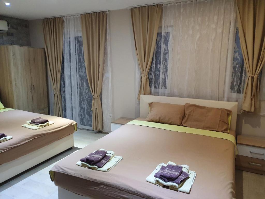 two beds in a room with towels on them at Apartments Tadic in Petrovac na Moru