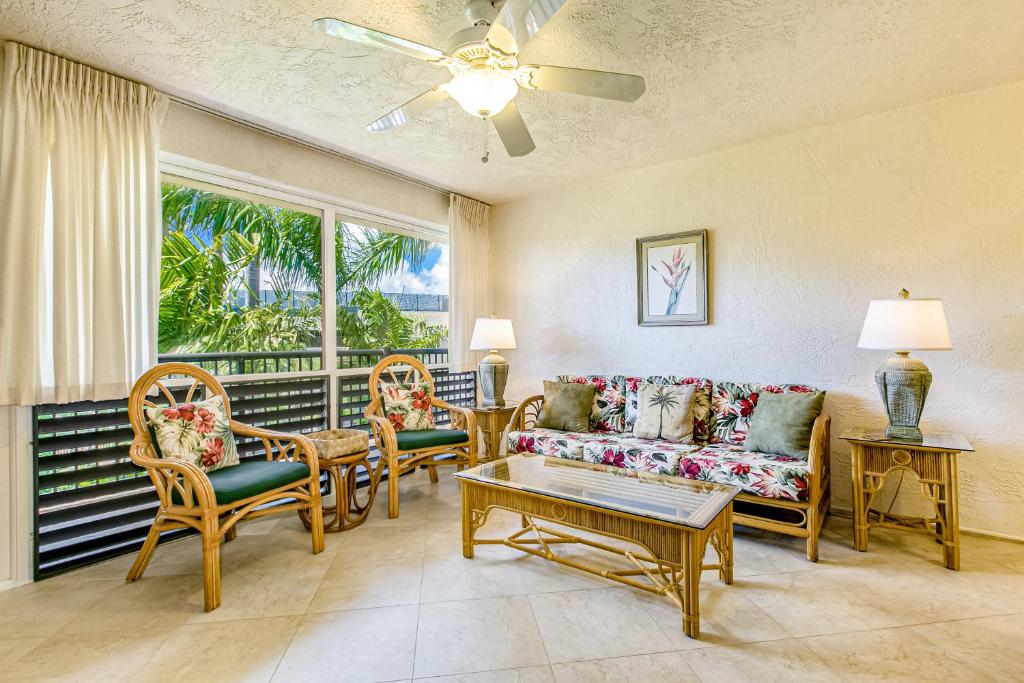 a living room with a couch and chairs and a window at Prince Kuhio 319 in Koloa