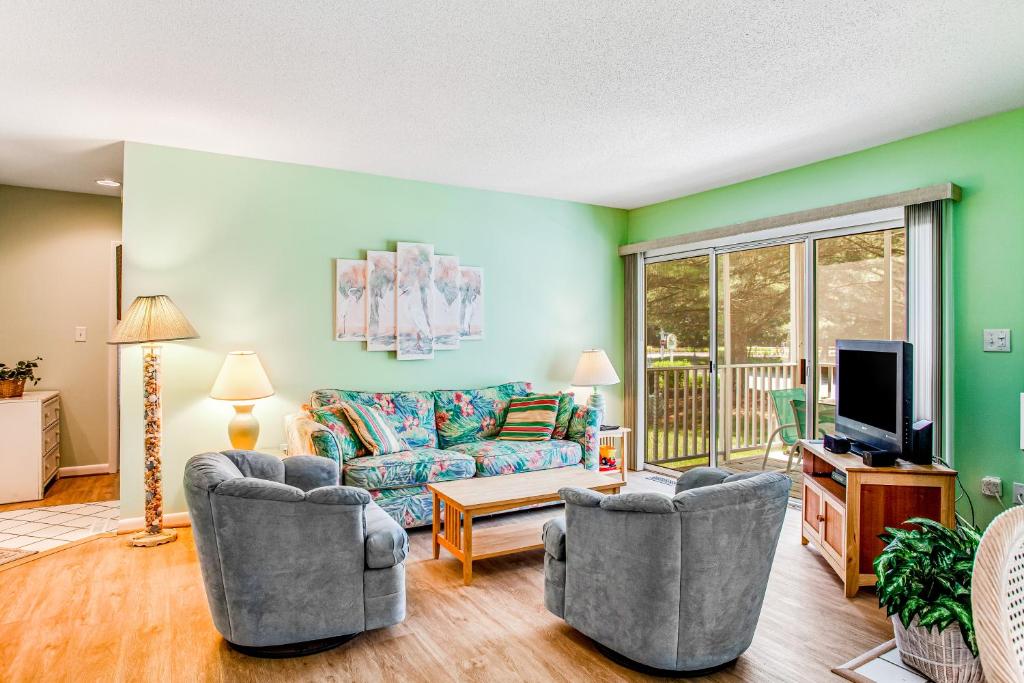 a living room with two chairs and a couch and a tv at Sea Colony --- 16004 Bayberry Court in Bethany Beach