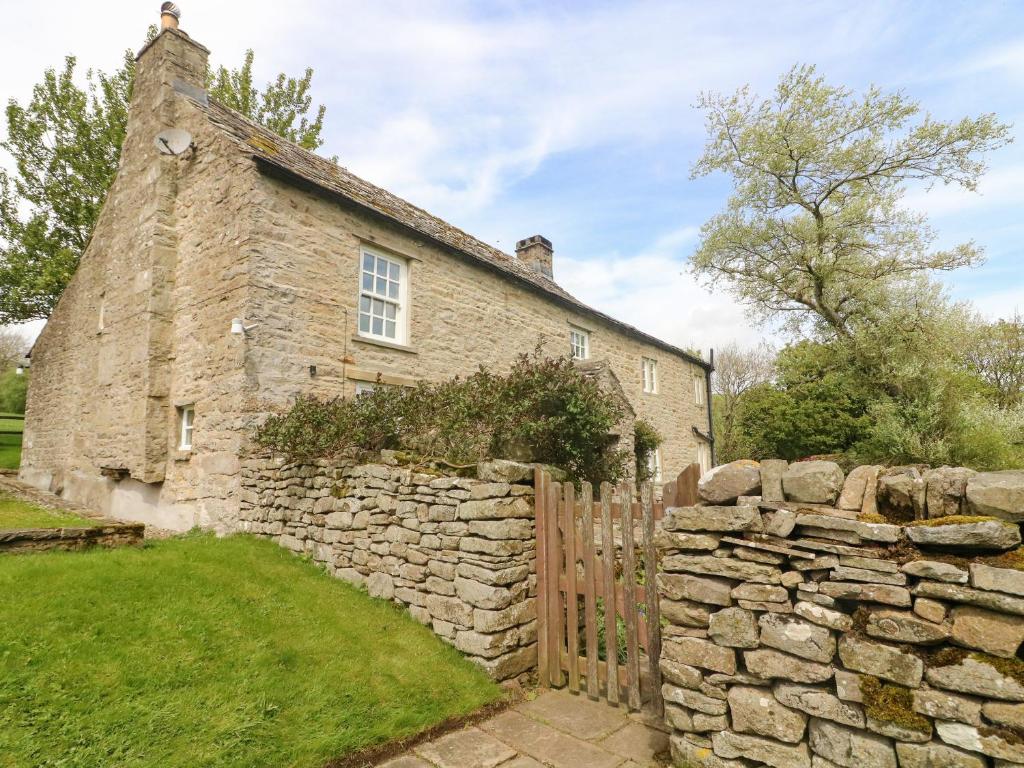 an old stone house with a stone fence at Cowstonegill in Bradley