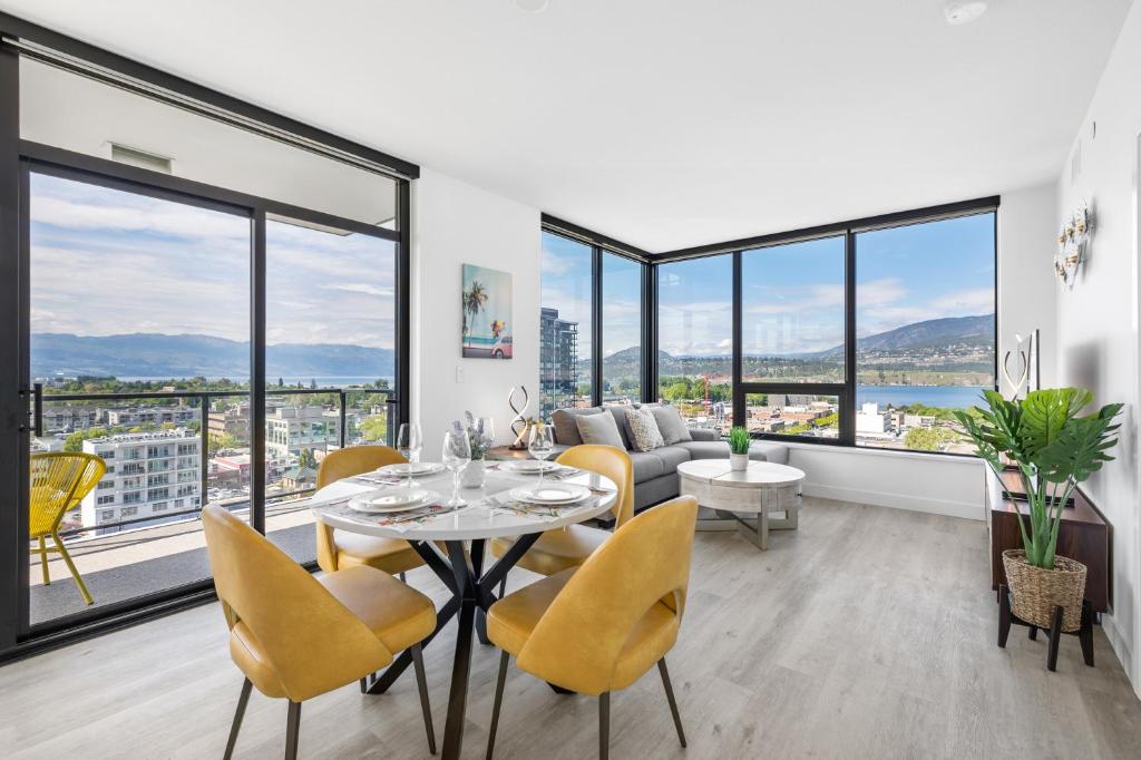 a living room with a table and chairs and a couch at Brand New Luxury Downtown Near the Beach #13 in Kelowna