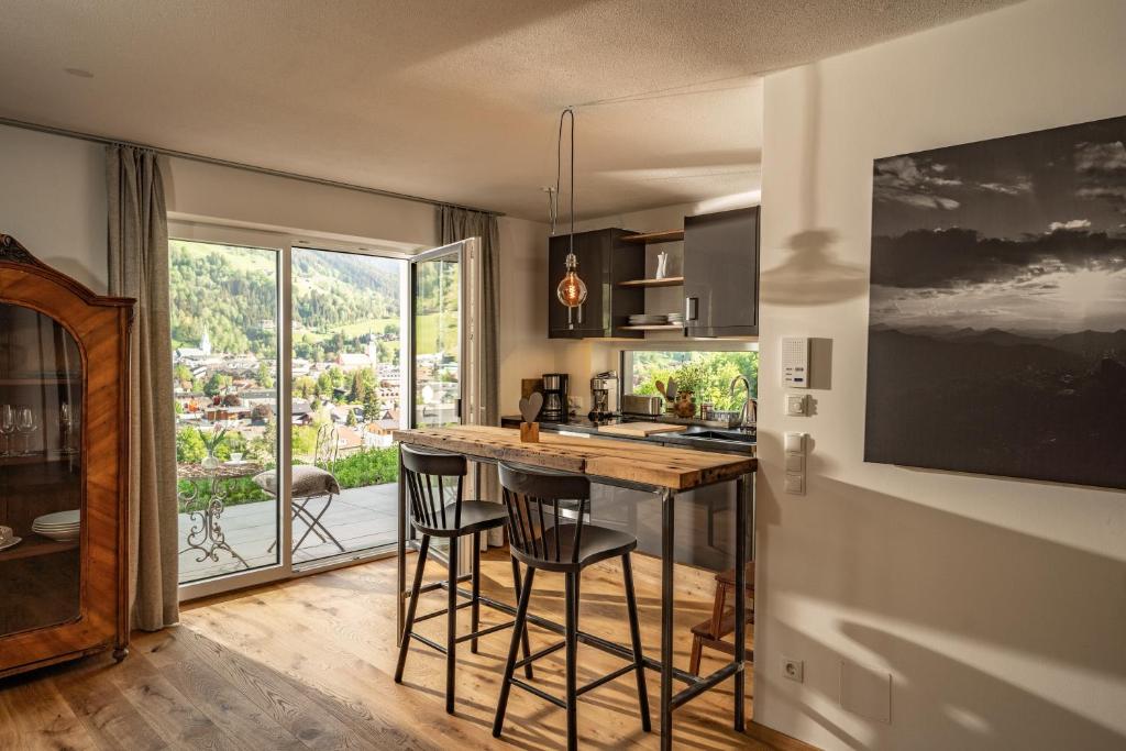 a kitchen with a table and chairs and a window at Alma&Antonia in Schladming