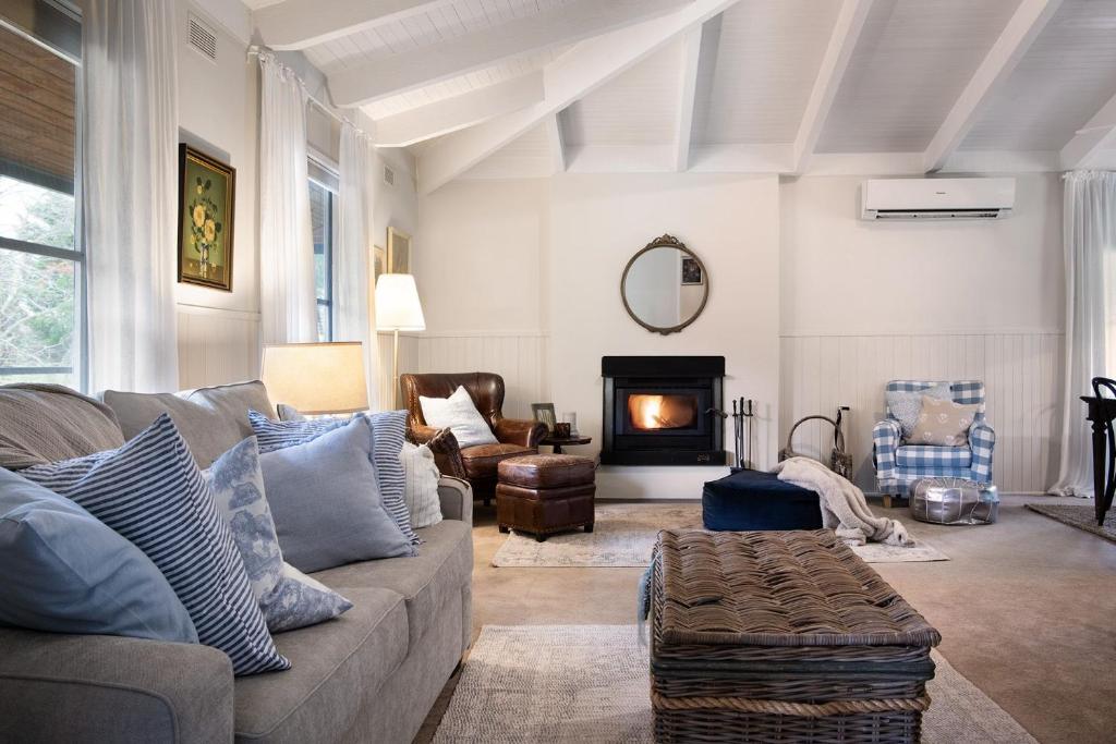 a living room with a couch and a fireplace at Maple Tree House- tranquil retreat in Musk Vale