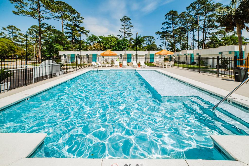 a swimming pool with blue water in a building at Island Villas in Gulf Shores