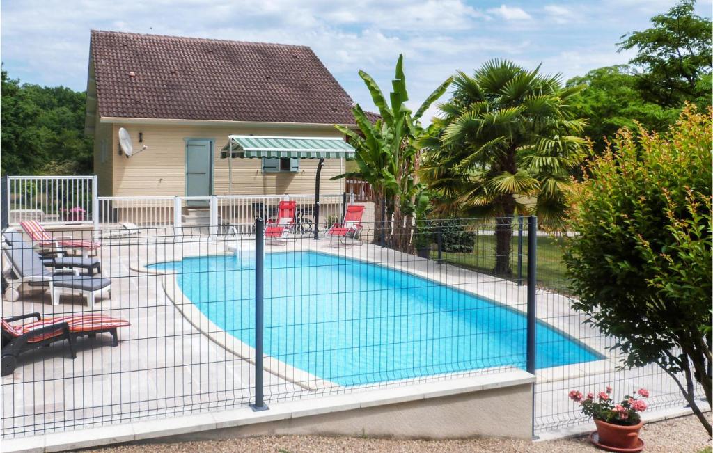 a fence around a swimming pool in a yard at Stunning Home In Sceau-saint-angel With Wifi in Nontron