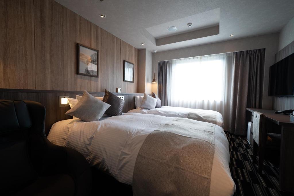 Postel nebo postele na pokoji v ubytování Hotel Grand View Takasaki