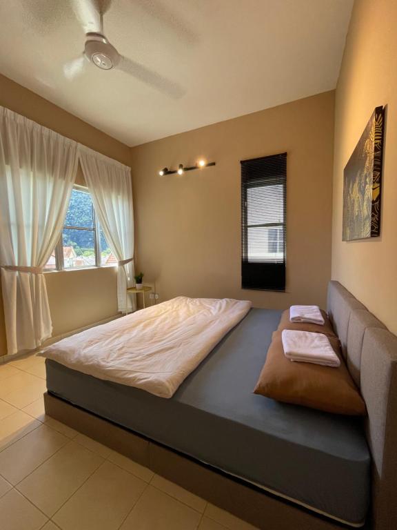 a large bed in a room with a window at MikasaCove @ Lost World of Tambun in Ipoh