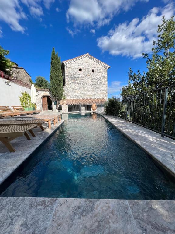 a swimming pool in the backyard of a house at Mas Saint Laurent in Les Salles-du-Gardon