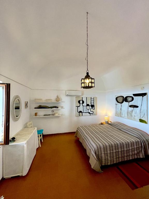 A bed or beds in a room at Dammuso "La Catalana"
