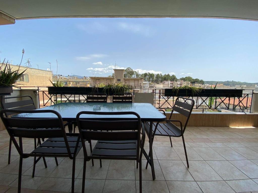 a table and chairs on a balcony with a view at Penthouse in center of sparta in Sparti