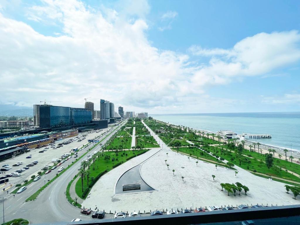 a city with a road and a beach and the ocean at Batumi Beach in Batumi