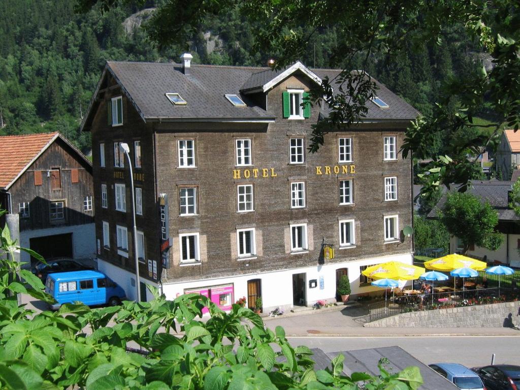 a large brown building with a hotel sign on it at Chalet Hotel Krone in Göschenen