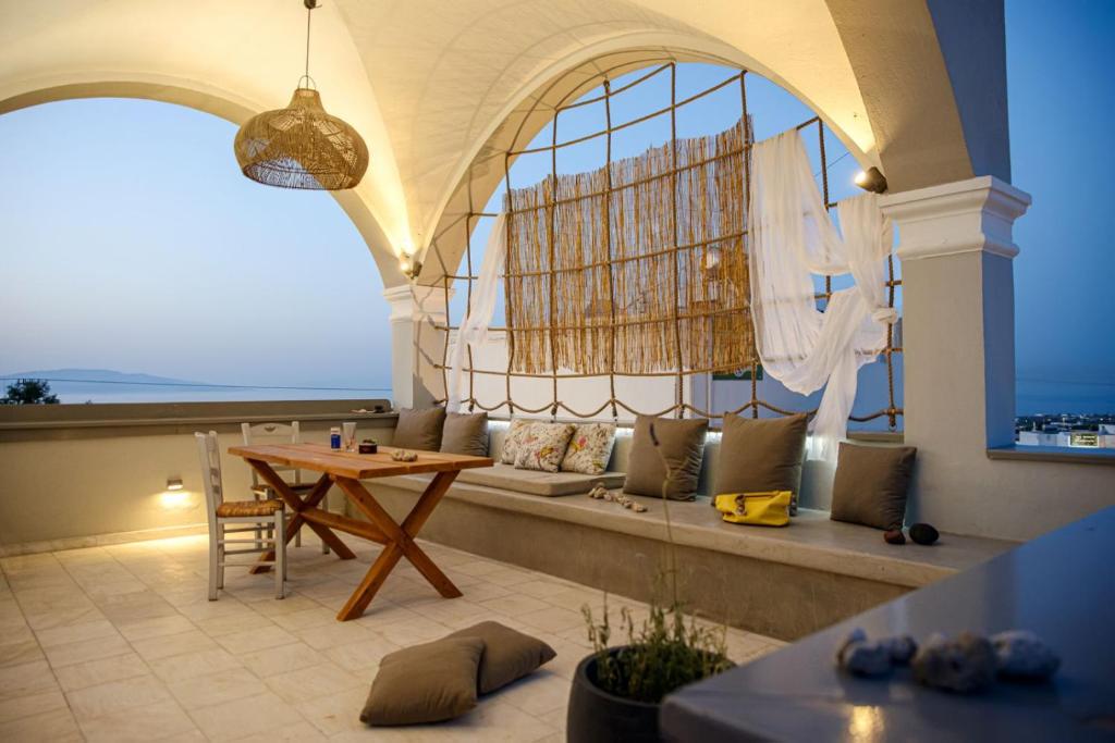 a living room with a couch and a table at Central Hostel Oia in Oia