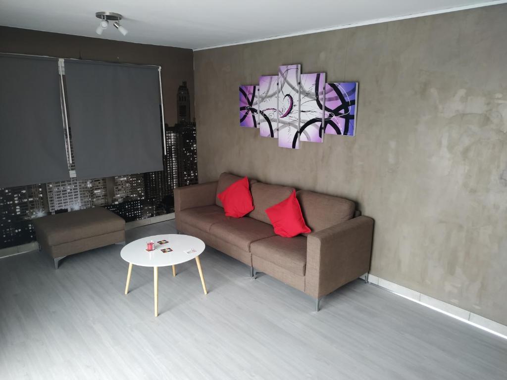 a living room with a couch and a table at Modern Suite, XL balcony, parking in Nicosia