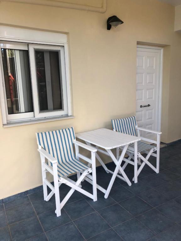 a table and two chairs sitting next to a window at Konstantina's House II in Koroni
