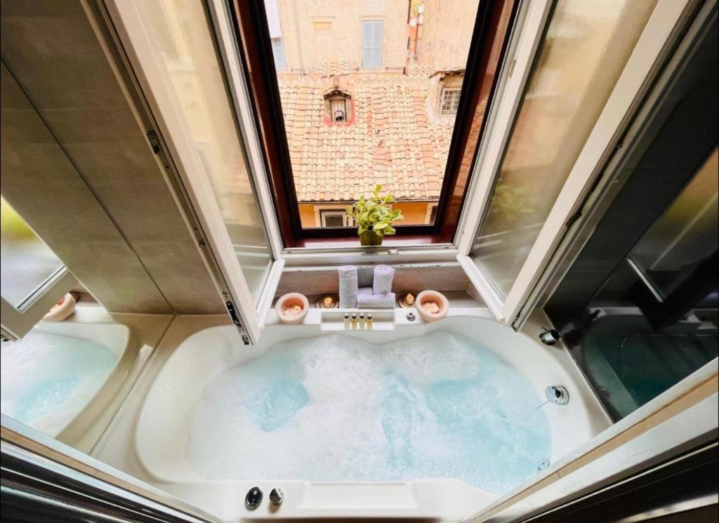 an overhead view of a bath tub with a window at Town House Spagna- luxury Rooms with Jacuzzi Bath in Rome