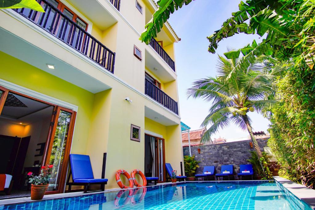 a villa with a swimming pool and a resort at Rural Scene Villa in Hoi An
