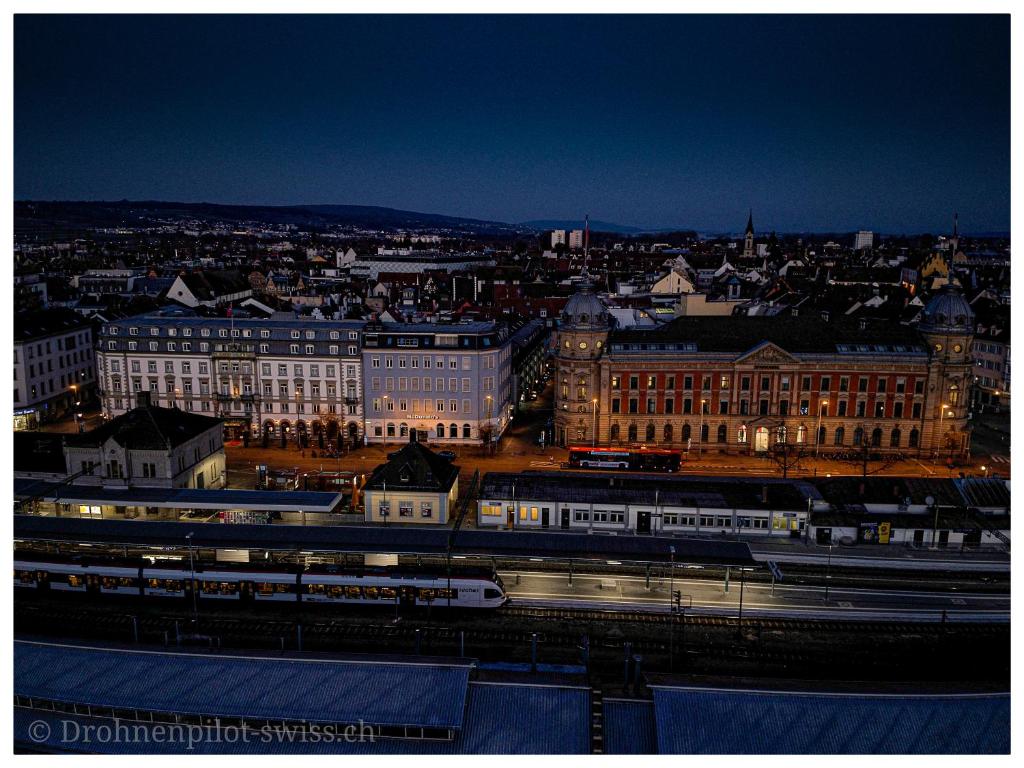a view of a city at night with trains at Hotel Alte Post in Konstanz