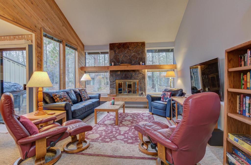 a living room filled with furniture and a fireplace at Quelah Condo - Unit 11 in Sunriver