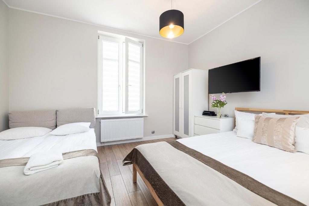 Posteľ alebo postele v izbe v ubytovaní Apartamenty Baltic