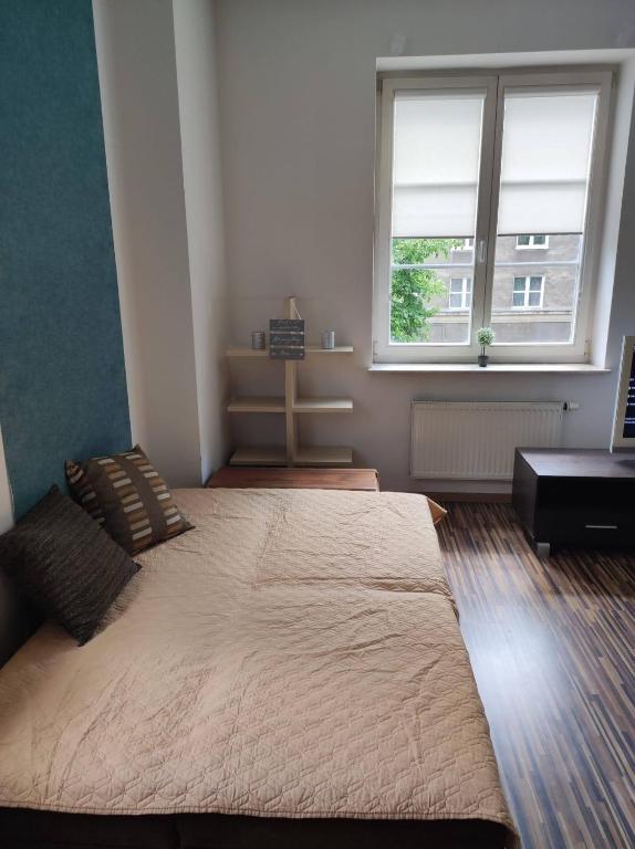 Posteľ alebo postele v izbe v ubytovaní Apartament przy Fontannie Neptuna
