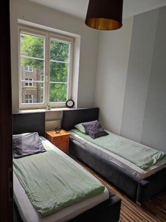 Posteľ alebo postele v izbe v ubytovaní Apartament przy Fontannie Neptuna