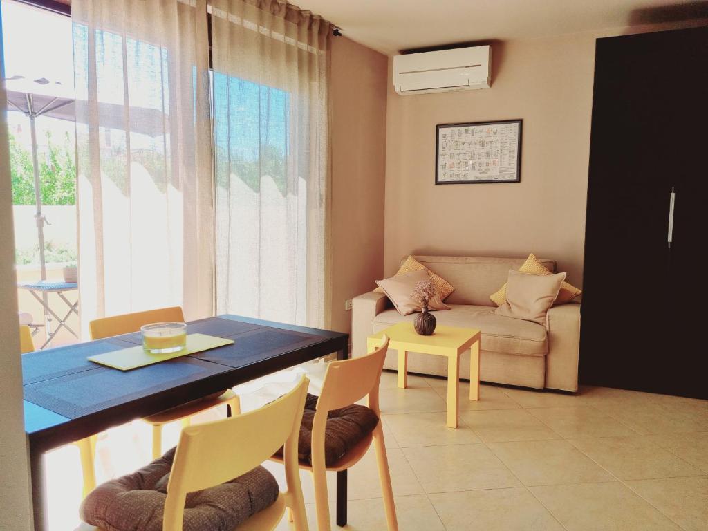 a living room with a table and a couch at Studio apartment Gemelli in Poreč