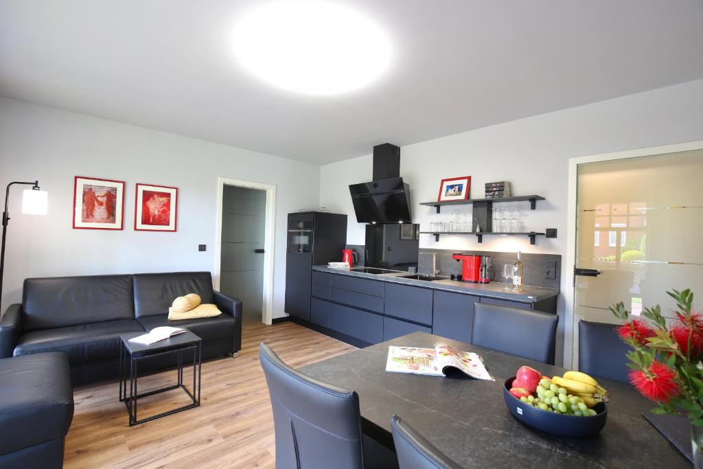 sala de estar con sofá y mesa en una habitación en Landhaus Lindenhof, Insel-Juwel, en Wangerooge