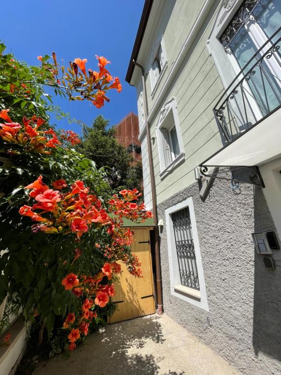 uma porta para uma casa com flores vermelhas em WelcomeVerona em Verona