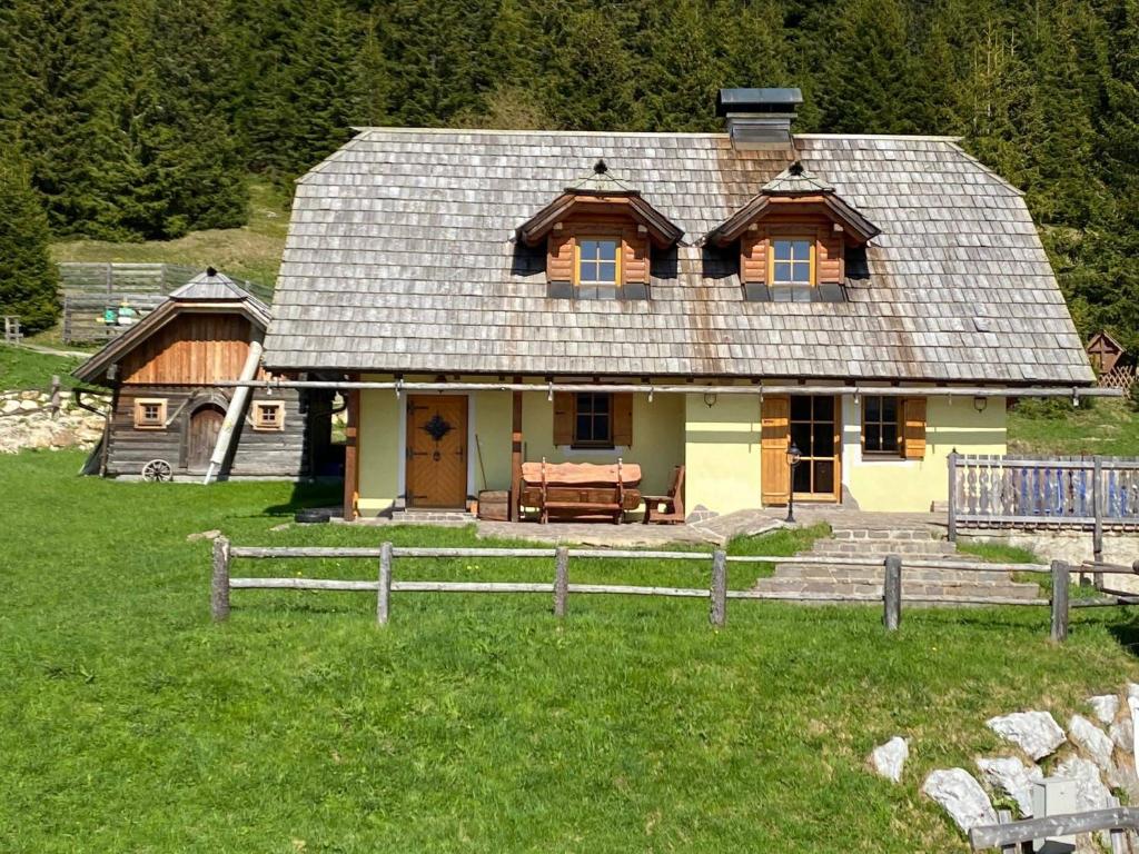 a large house in a field with a fence at Lachtalhütte in Lachtal