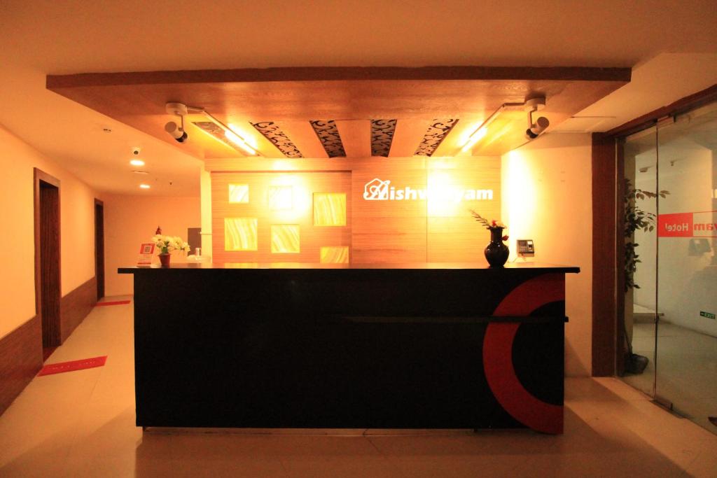 a store front with a black counter in a room at Aishwaryam Hotel in Tallākulam