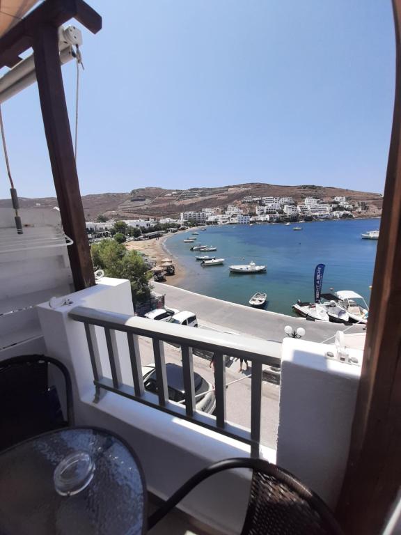 a balcony with a view of a harbor with boats in the water at ΚΥΘΝΟΣ LAREROOMS in Mérikhas