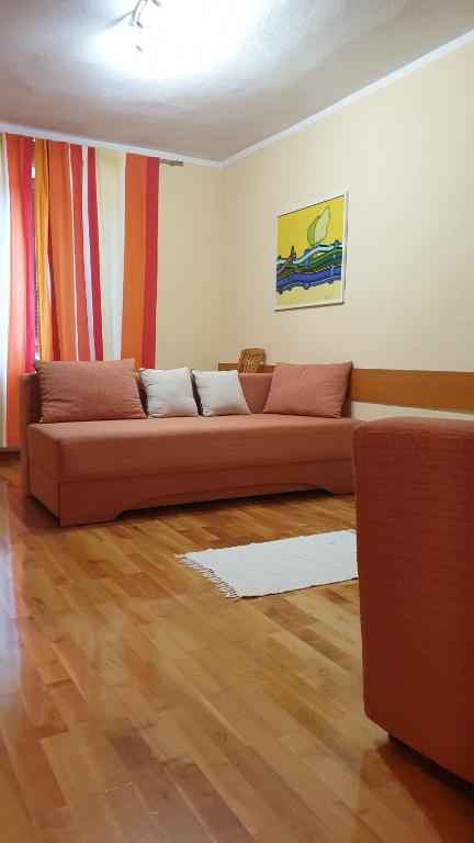a living room with a couch in a room at GABY apartment-center of Plitvička Jezera in Plitvička Jezera