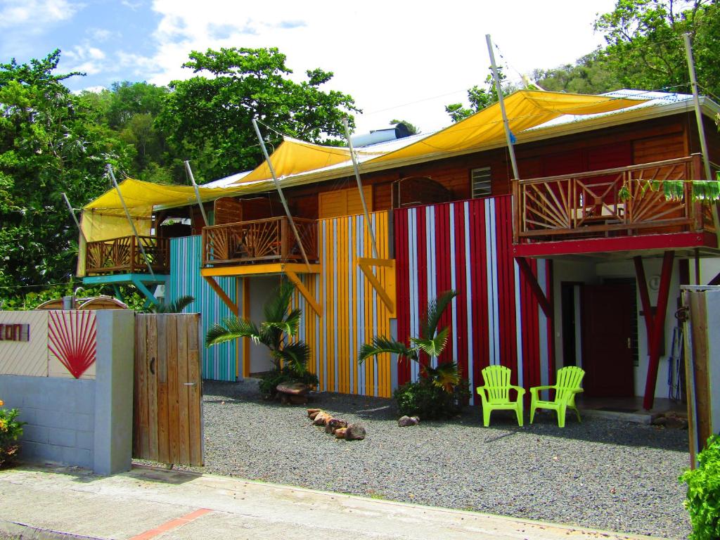 a house with a colorful facade with two decks at Katalo Plage in Deshaies