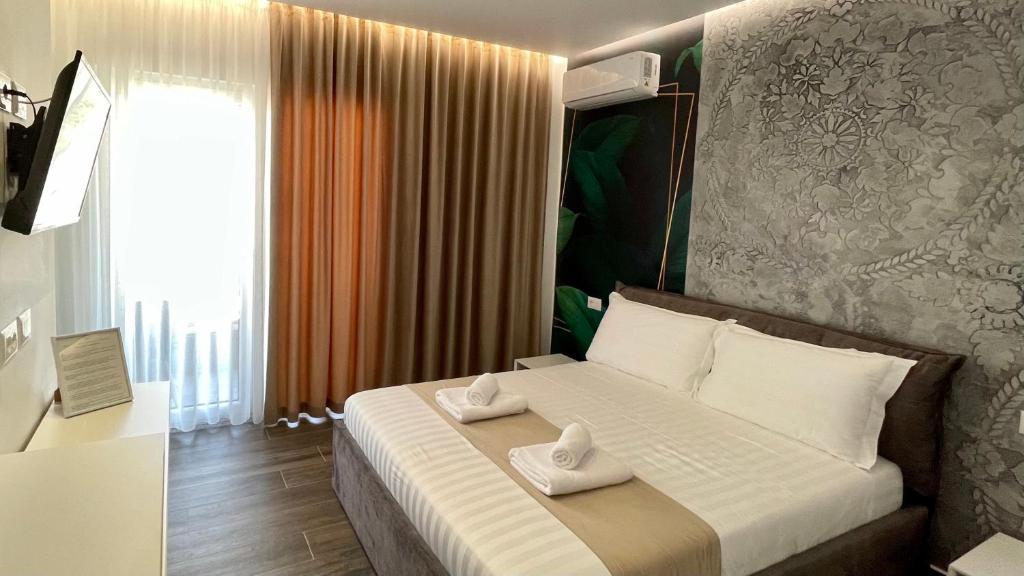 Postel nebo postele na pokoji v ubytování Vila Llanaj