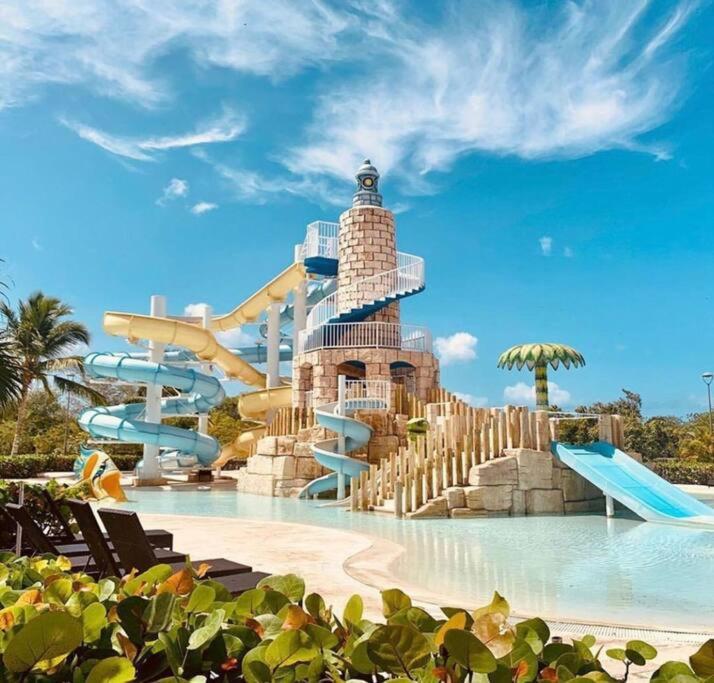 a water slide at a resort with a water park at Fabulous Caracol Cadaques Caribe in Bayahibe