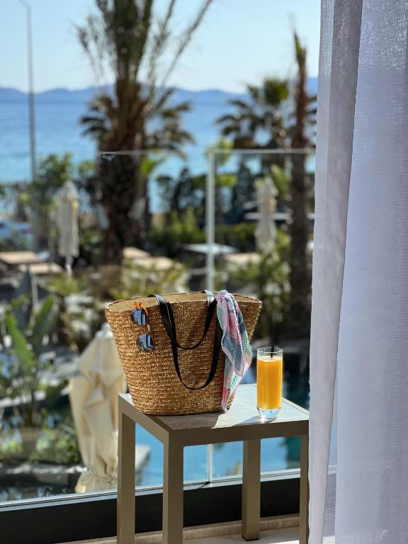 a table with a basket and a glass of orange juice at Rammos Managed By Dedeman in Bodrum City
