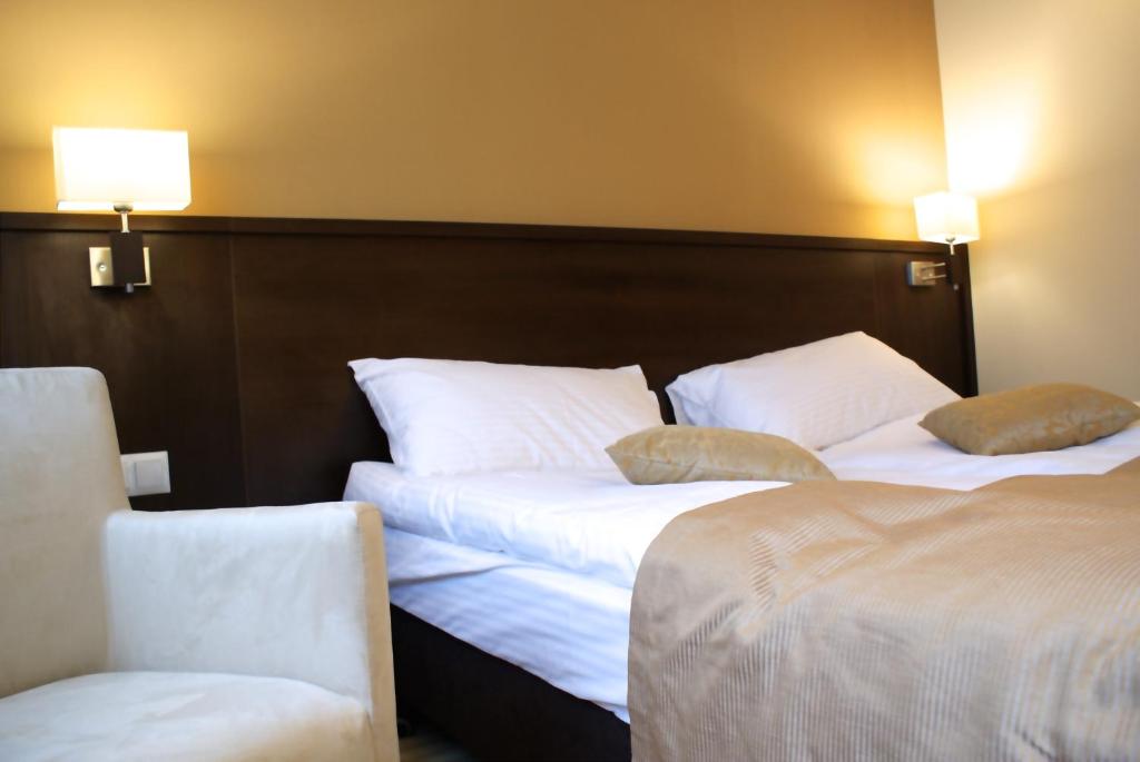 Łóżko lub łóżka w pokoju w obiekcie Hotel Lazur SPA & Conference