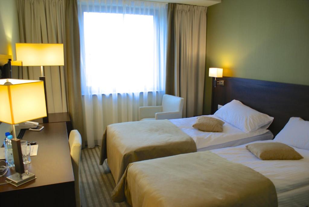 Łóżko lub łóżka w pokoju w obiekcie Hotel Lazur SPA & Conference