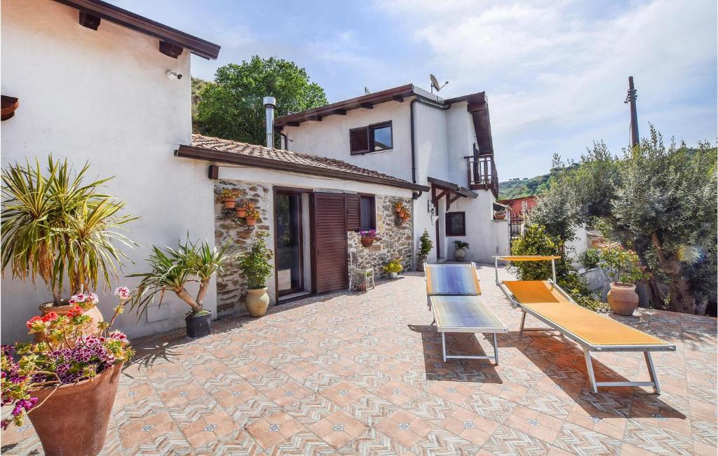 um pátio com um banco e uma casa em 2 Bedroom Gorgeous Home In Motta San Giovanni em Motta San Giovanni