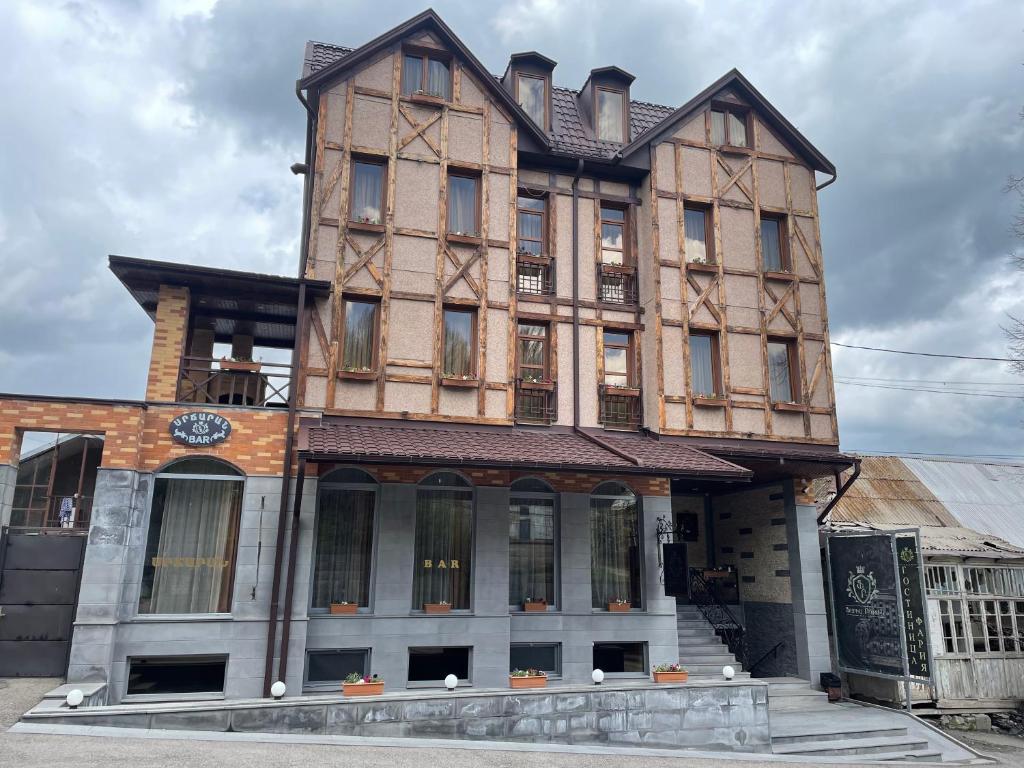 a large building with a clock on it at Faria Boutique Hotel in Tsaghkadzor