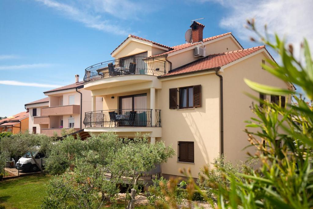 a building with balconies on the side of it at Apartments Otia Seaview in Porat