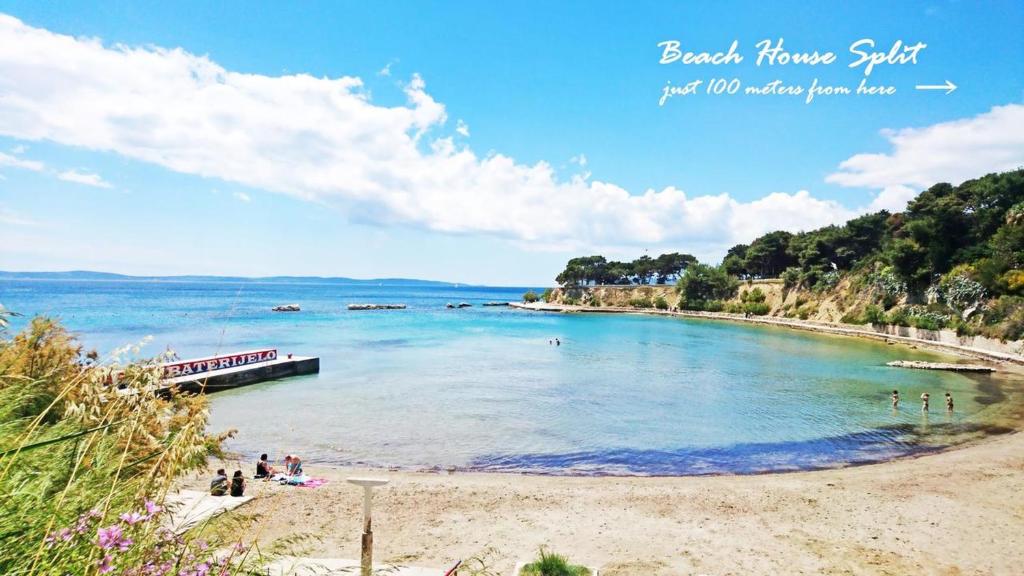 a view of a beach with people in the water at Beach House Split in Split