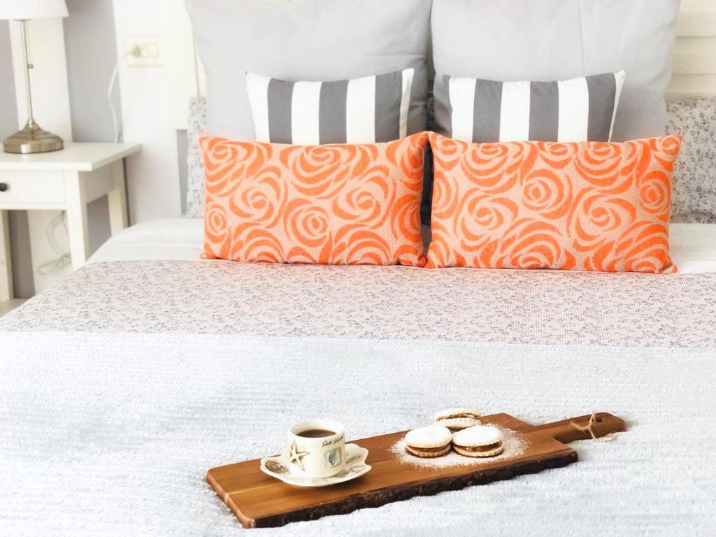 a tray with a coffee cup and slippers on a bed at Apartamento con vistas al mar en Primera Línea. in Muros