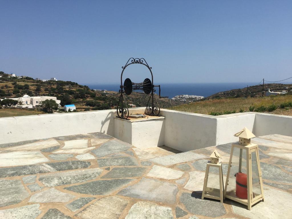 a stone patio with a light on top of a building at Maison de Bizou in Sifnos