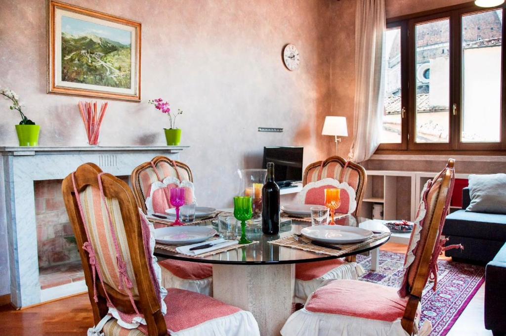 a dining room with a table and four chairs at Cozy CENTRAL apartment in Florence - spectacular views of Duomo in Florence