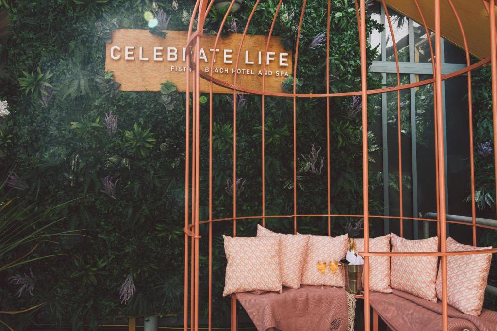 a metal gate with pillows in front of a building at Fistral Beach Hotel and Spa - Adults Only in Newquay